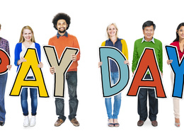 People Holding Pay Day Sign